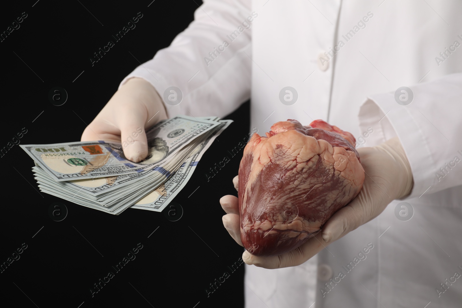 Photo of Doctor with heart and dollar banknotes on black background, closeup