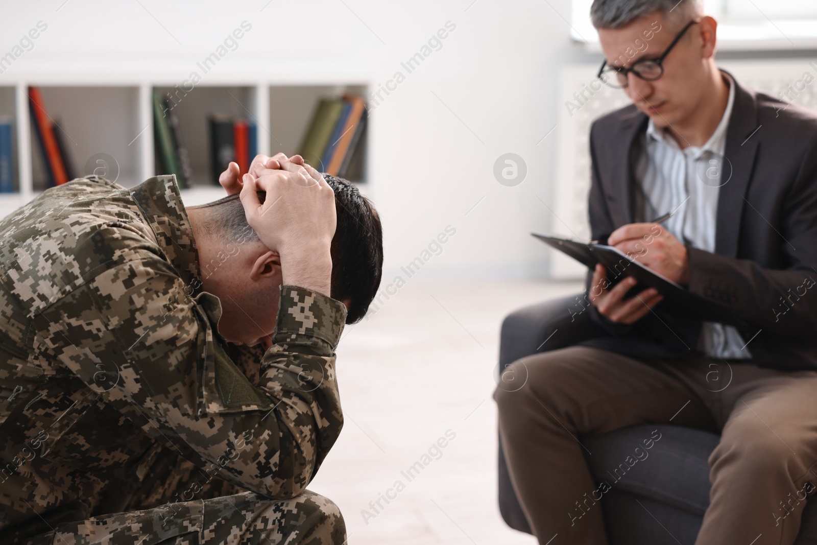 Photo of Professional psychotherapist working with military man in office