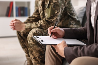 Professional psychotherapist working with military man in office, closeup