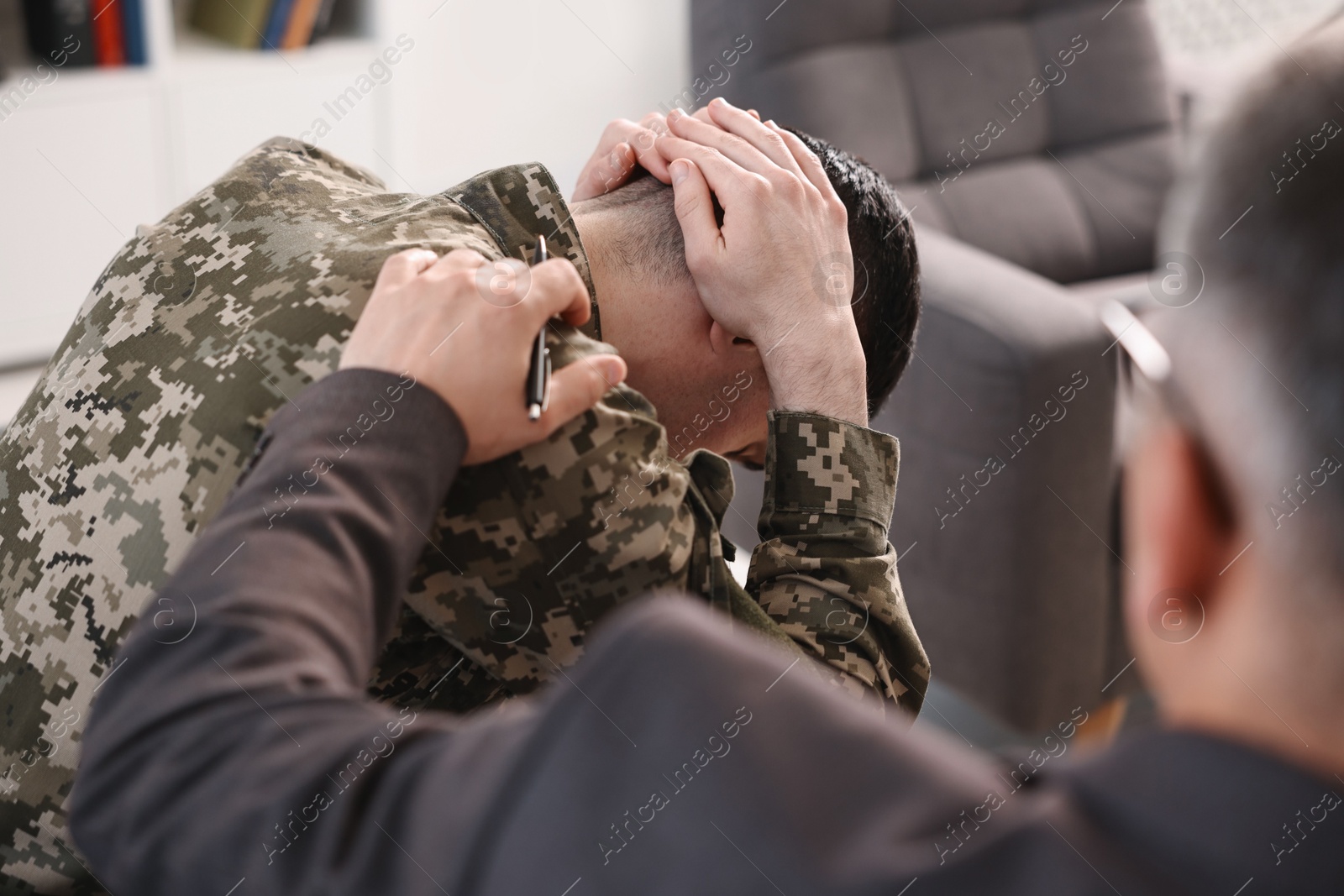 Photo of Professional psychotherapist working with military man in office, closeup