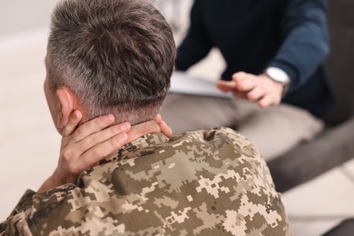 Professional psychotherapist working with military man in office, closeup