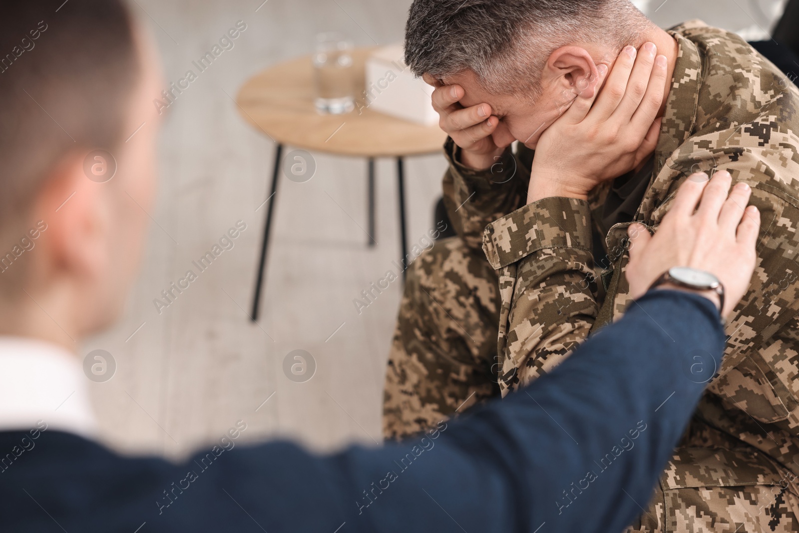 Photo of Professional psychotherapist working with military man in office