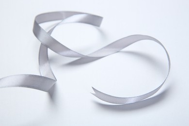 Photo of One beautiful grey ribbon on white background