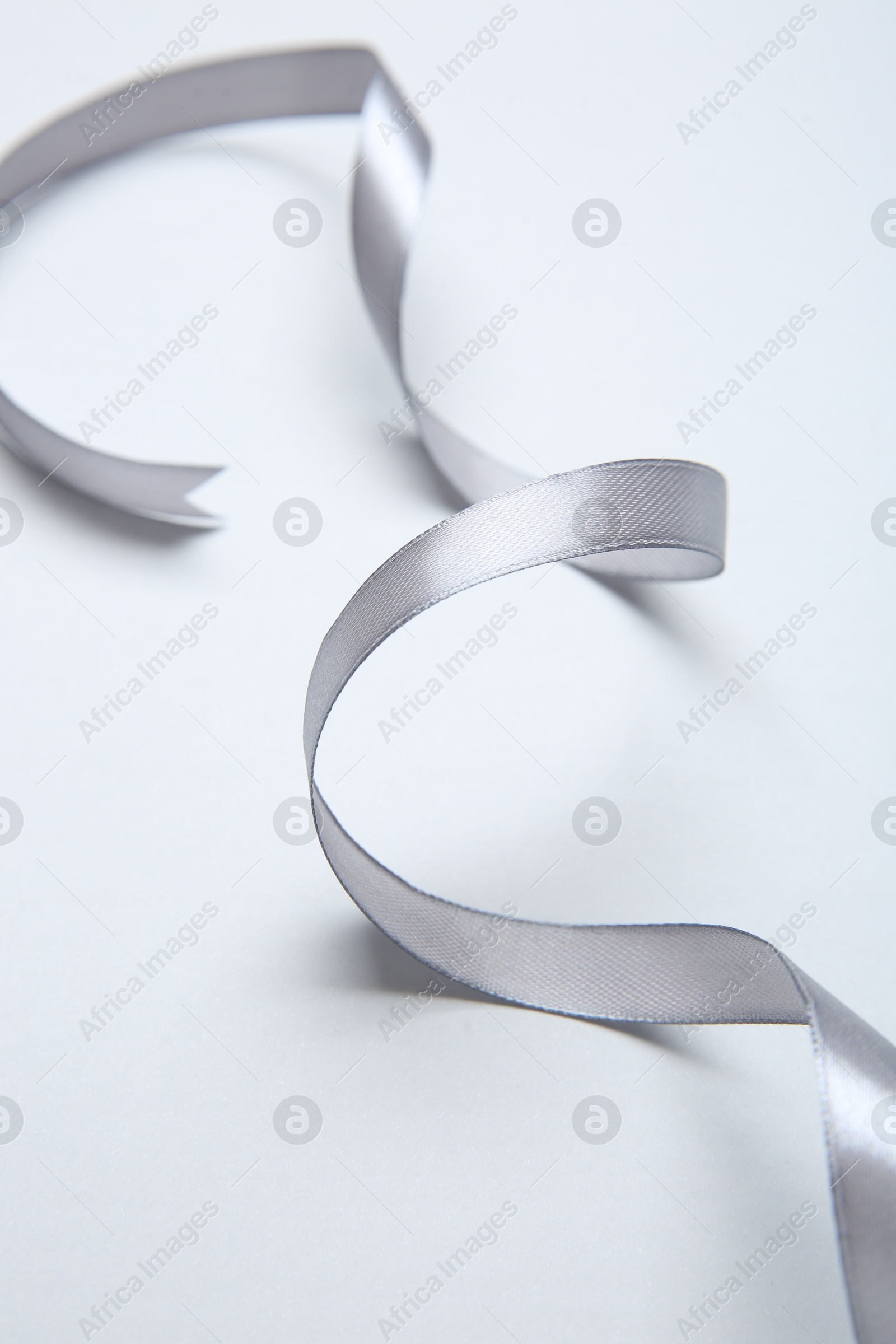 Photo of One beautiful grey ribbon on white background