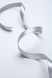 One beautiful grey ribbon on white background