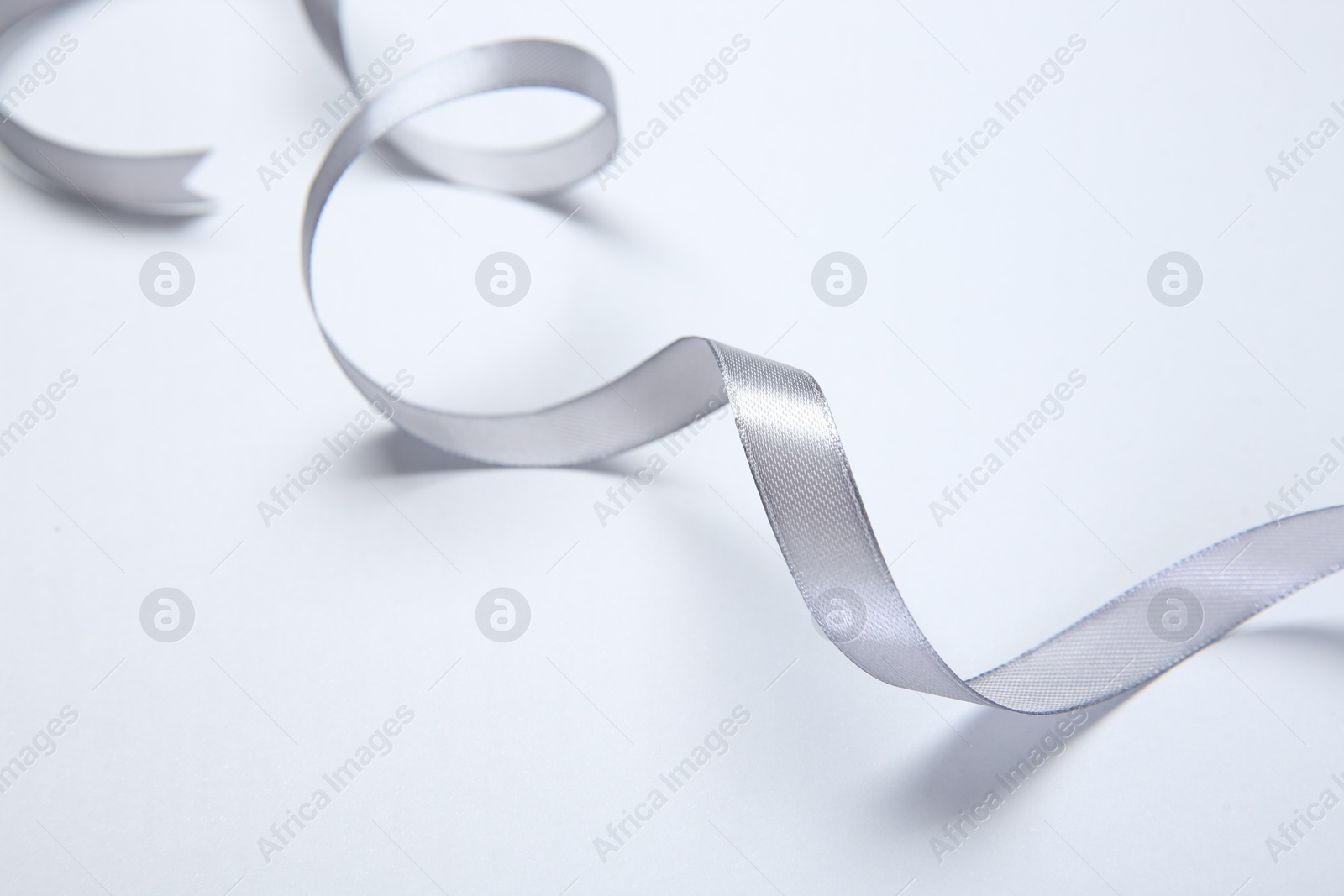 Photo of One beautiful grey ribbon on white background