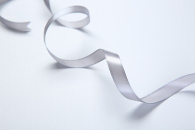 One beautiful grey ribbon on white background