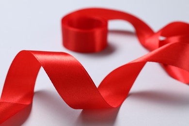 One beautiful red ribbon on white background, closeup