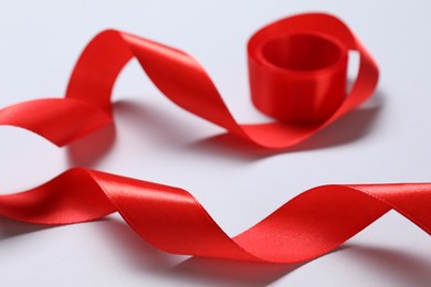 One beautiful red ribbon on white background, closeup