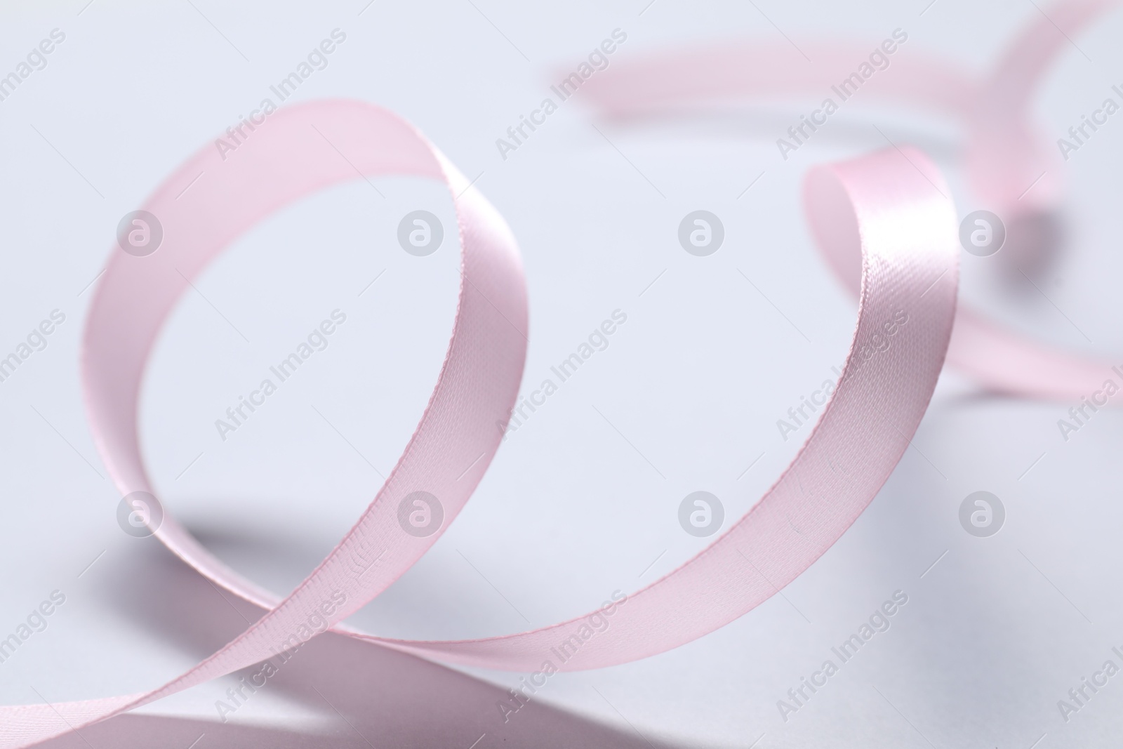 Photo of One beautiful pink ribbon on white background