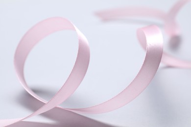 Photo of One beautiful pink ribbon on white background