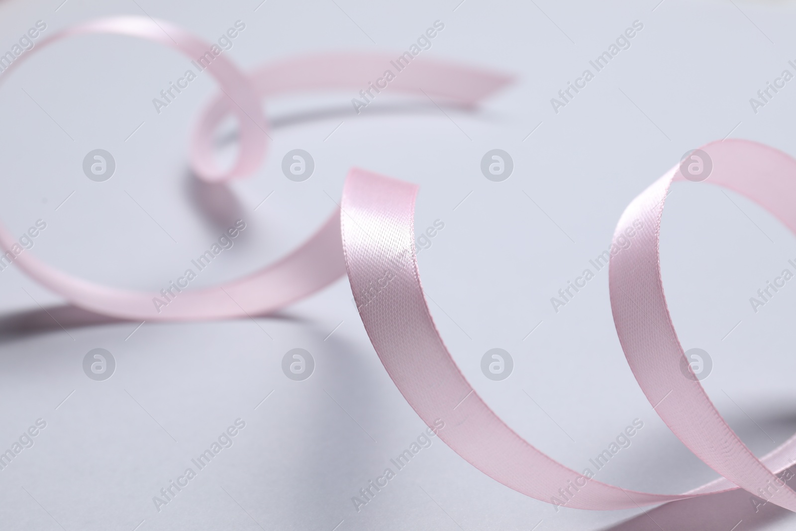 Photo of One beautiful pink ribbon on white background