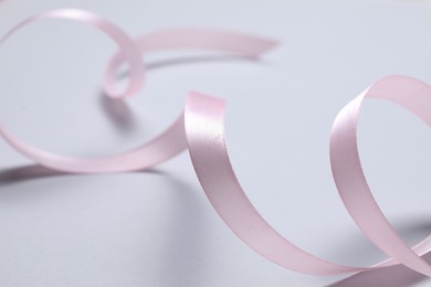 Photo of One beautiful pink ribbon on white background