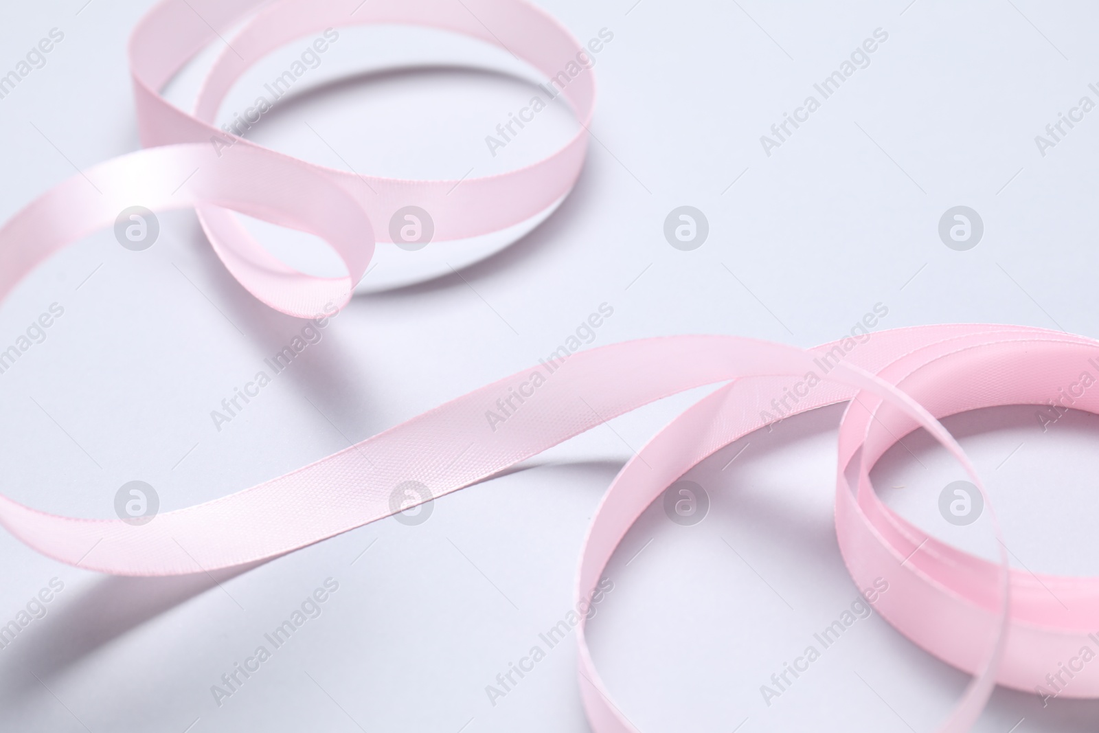 Photo of One beautiful pink ribbon on white background