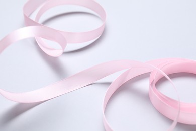 Photo of One beautiful pink ribbon on white background