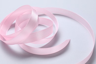 Photo of One beautiful pink ribbon on white background