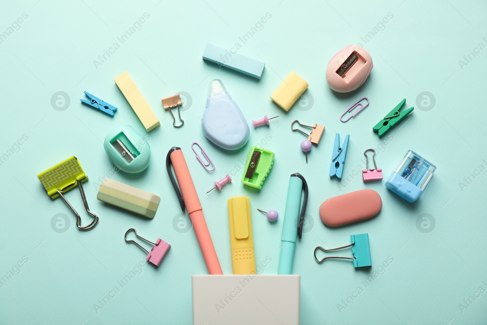 Photo of Flat lay composition with holder and different stationery on turquoise background