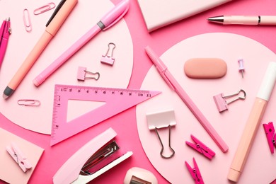 Flat lay composition with stapler and different stationery on pink background