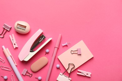 Photo of Flat lay composition with stapler and different stationery on pink background, space for text