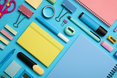 Photo of Flat lay composition with notebook and different stationery on light blue background