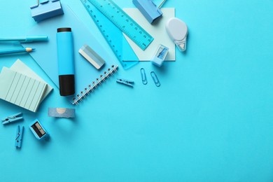 Photo of Flat lay composition with notebook and different stationery on light blue background, space for text