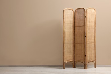 Photo of One folding screen near beige wall indoors, space for text