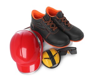 Pair of working boots, hard hat, earmuffs and goggles isolated on white