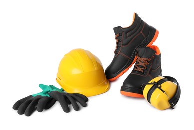 Photo of Pair of working boots, hard hat, earmuffs and gloves isolated on white