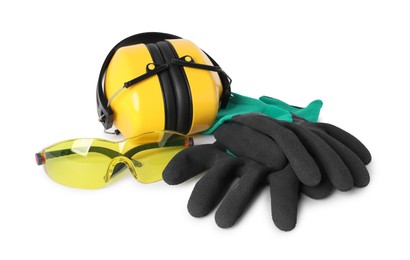 Photo of Earmuffs, protective gloves and goggles isolated on white