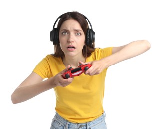 Shocked woman in headphones playing video game with controller on white background