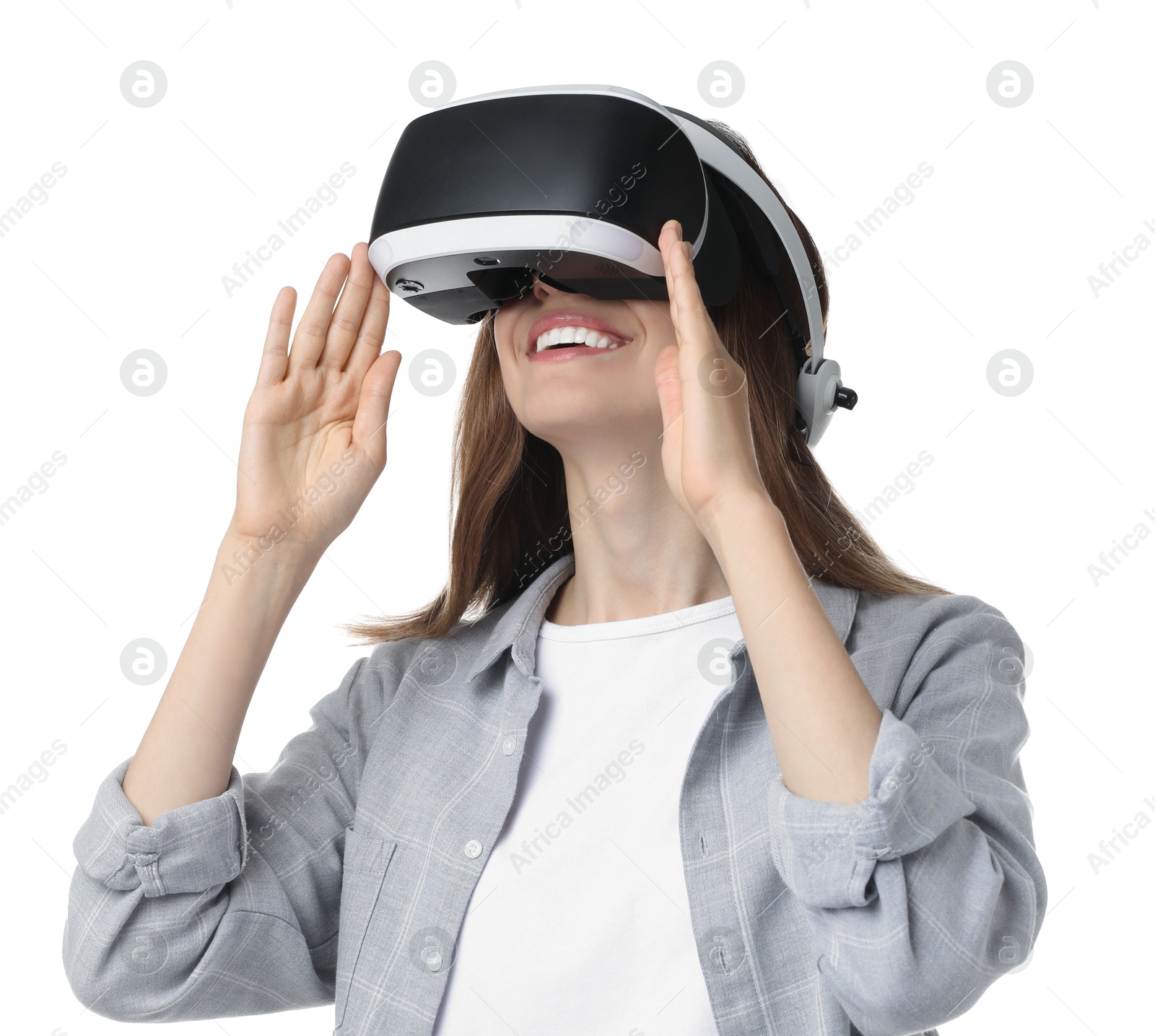 Photo of Smiling woman using virtual reality headset on white background