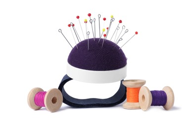 Blue pincushion with sewing pins and spools of threads isolated on white