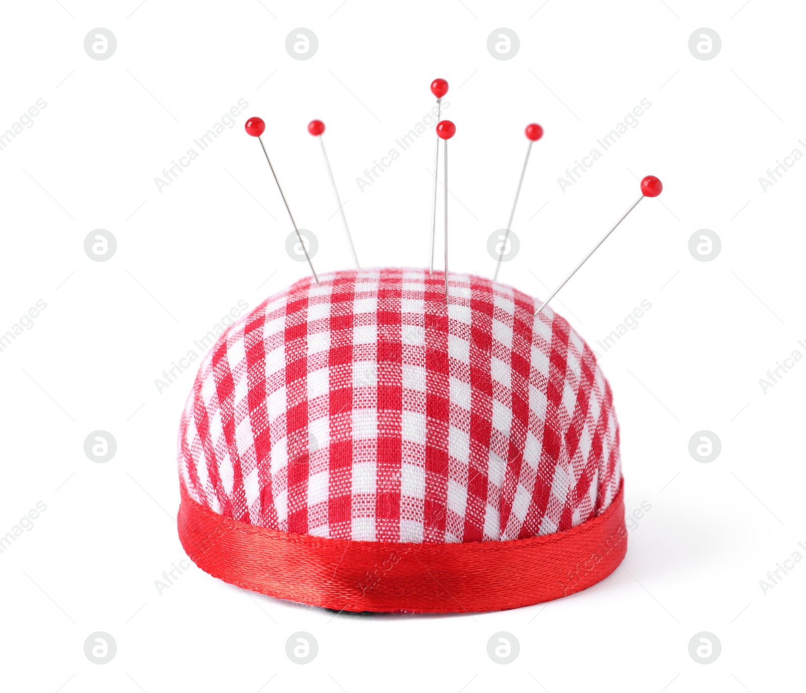 Photo of Red pincushion with sewing pins isolated on white