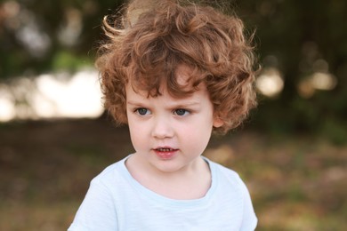 Photo of Portrait of little boy outdoors. Cute child