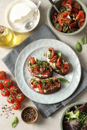 Delicious bruschettas with ricotta cheese, tomatoes, arugula, salad and peppercorns on light table, flat lay