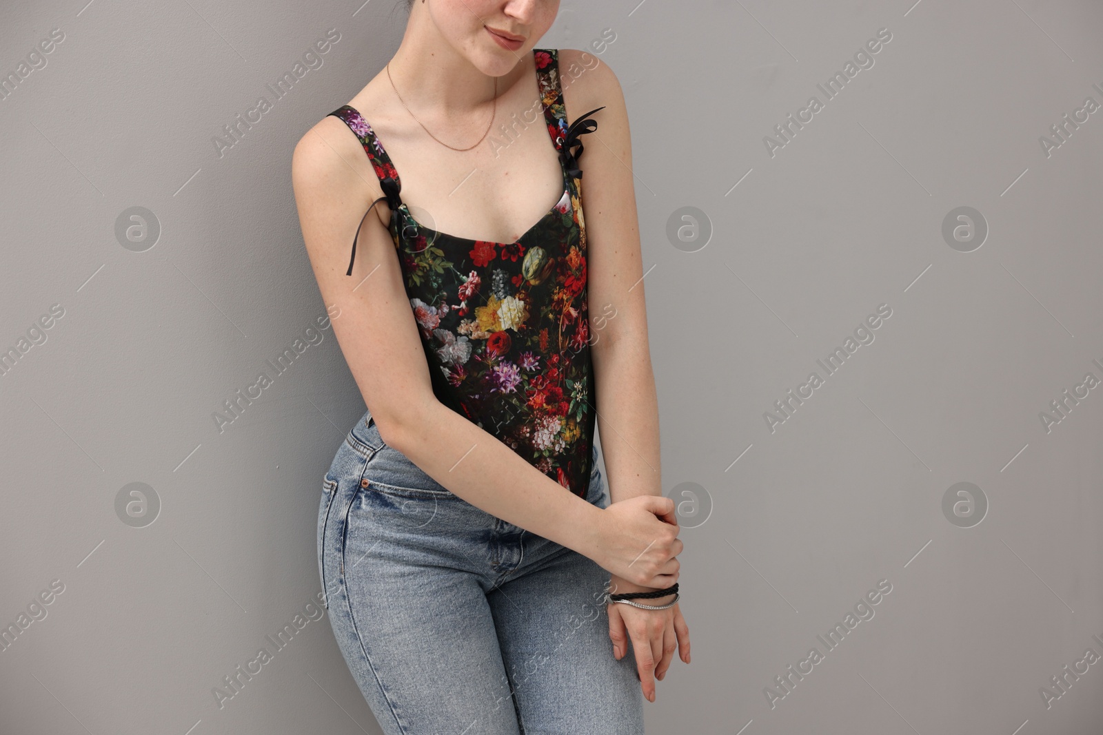 Photo of Woman in stylish corset on grey background, closeup