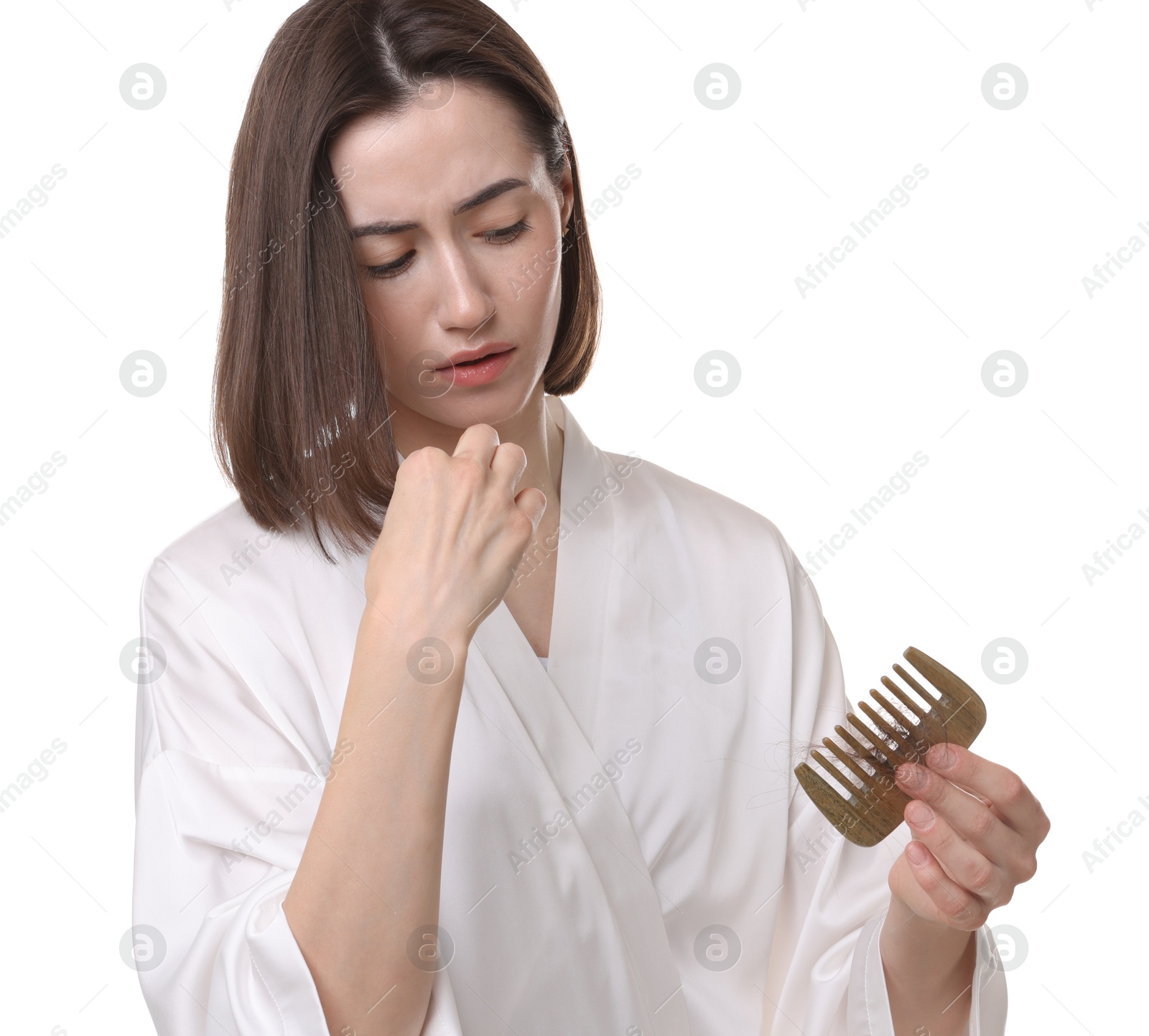 Photo of Stressed woman holding comb with lost hair on white background. Alopecia problem