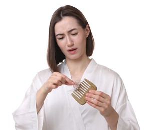 Emotional woman taking her lost hair from comb on white background. Alopecia problem