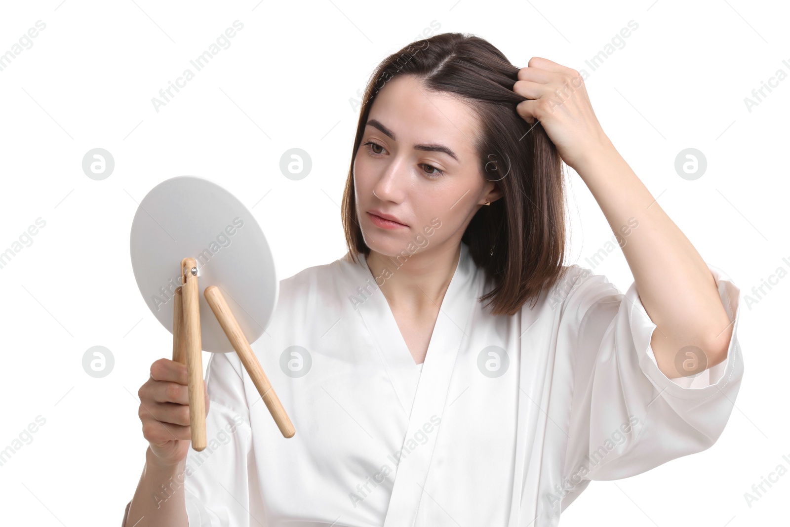 Photo of Young woman with hair loss problem looking at mirror on white background