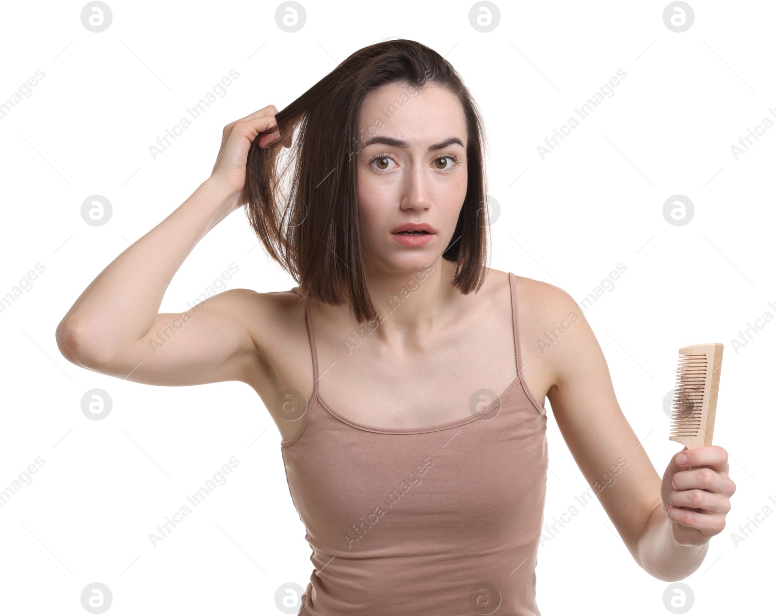 Photo of Stressed woman holding comb with lost hair on white background. Alopecia problem