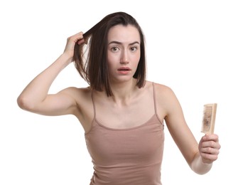 Photo of Stressed woman holding comb with lost hair on white background. Alopecia problem