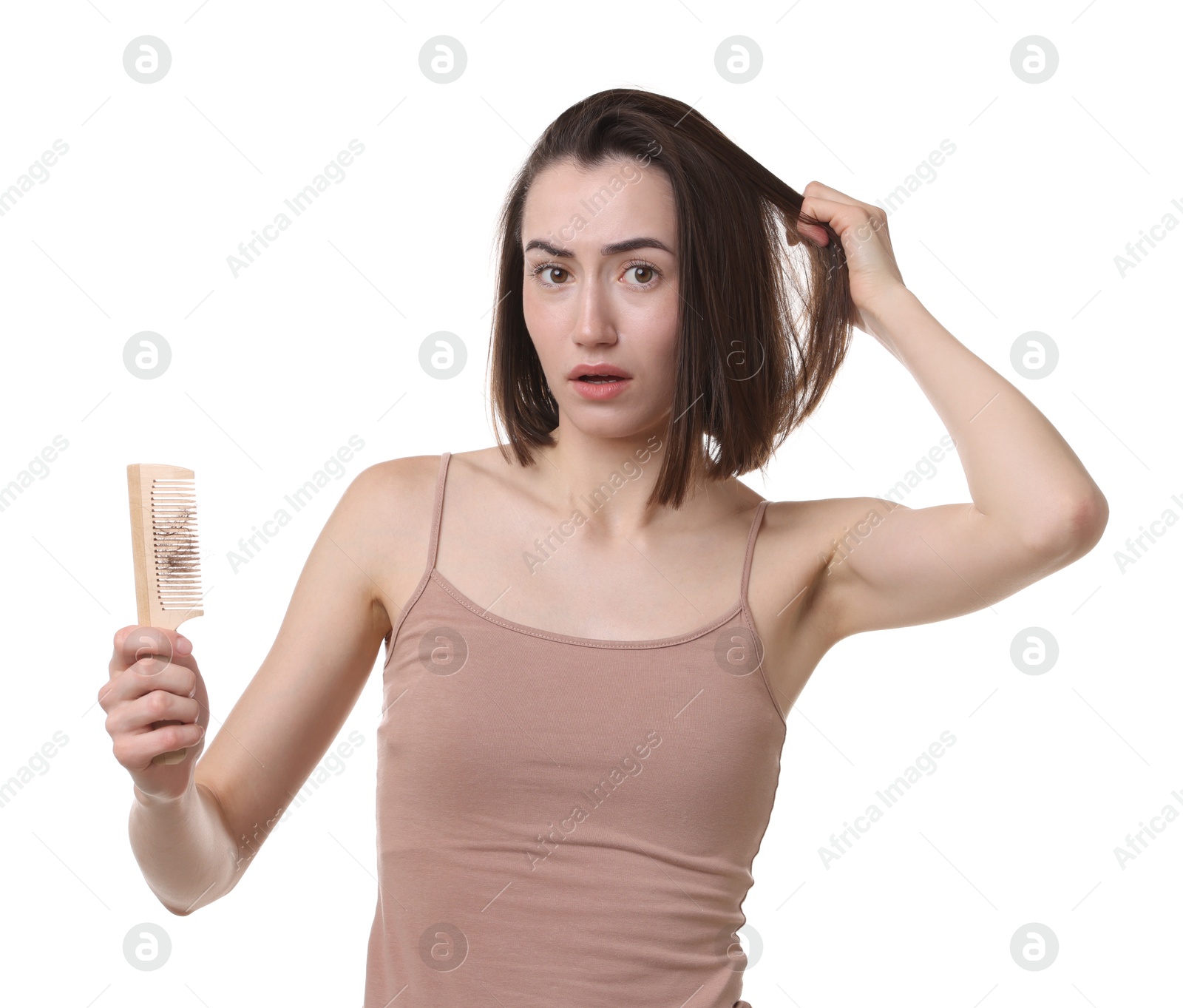 Photo of Stressed woman holding comb with lost hair on white background. Alopecia problem