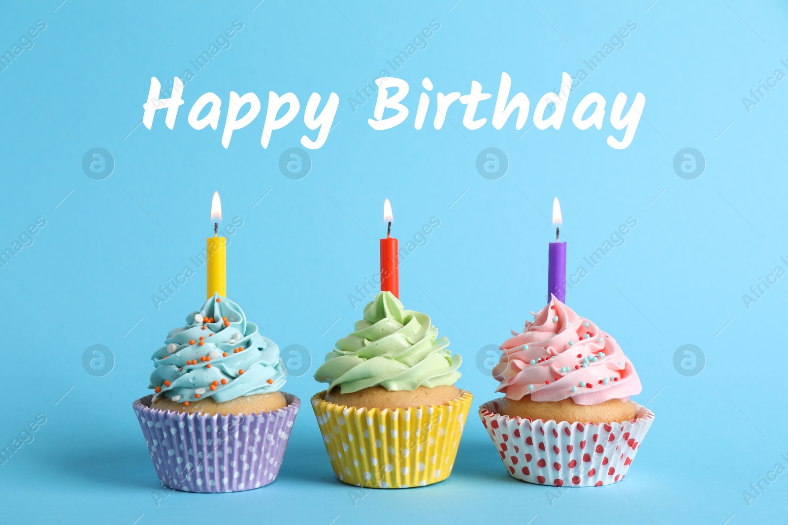 Image of Happy Birthday. Cupcakes with candles on light blue background