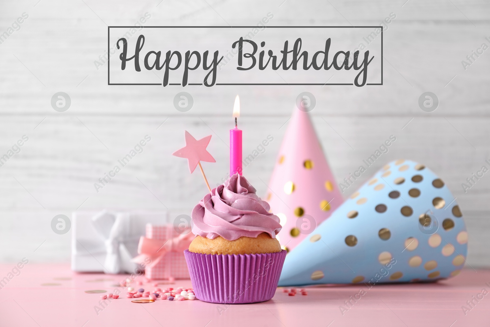 Image of Birthday card with cupcake, gift boxes and party hats on pink table