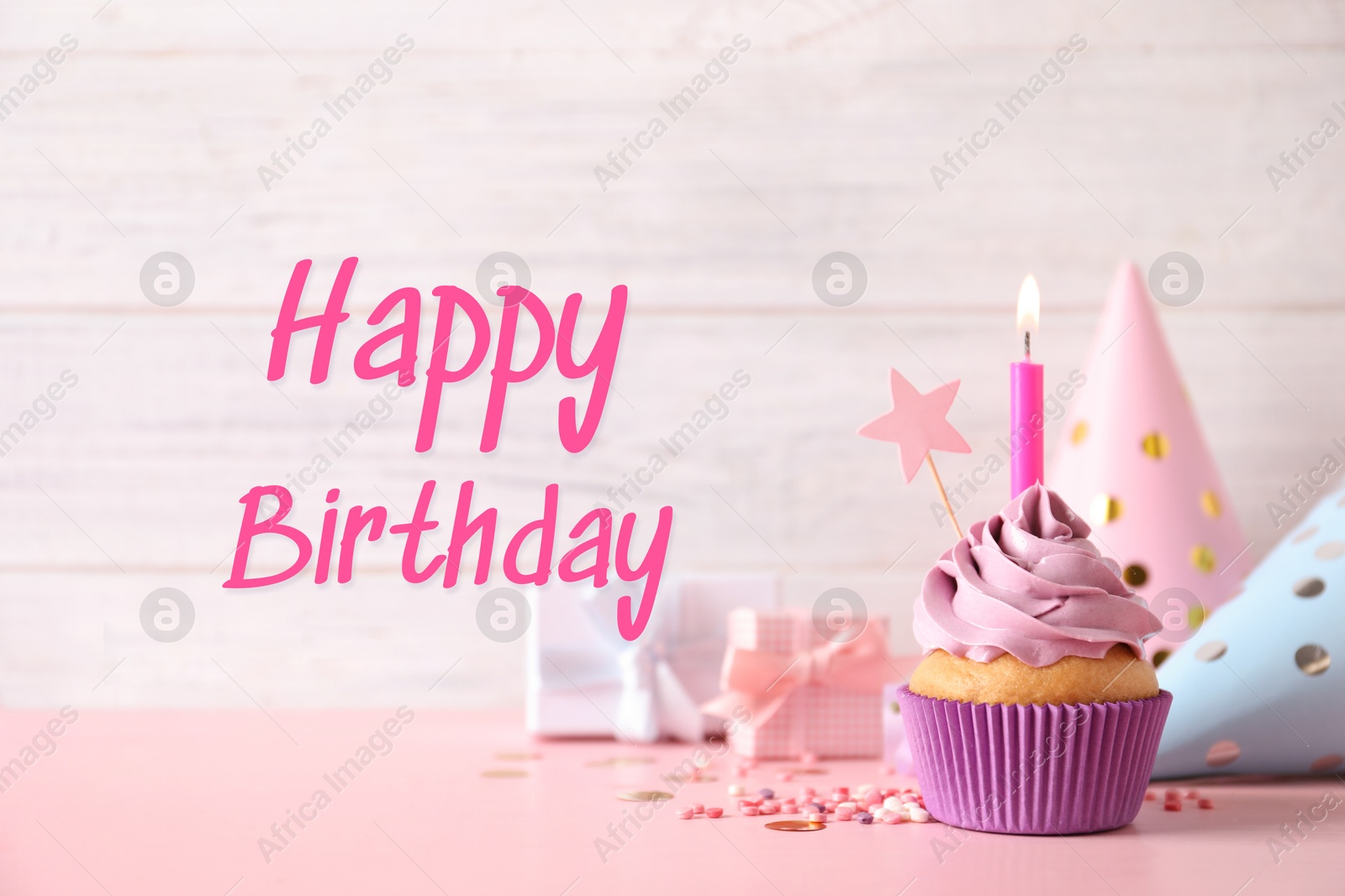 Image of Birthday card with cupcake, gift boxes and party hats on pink table