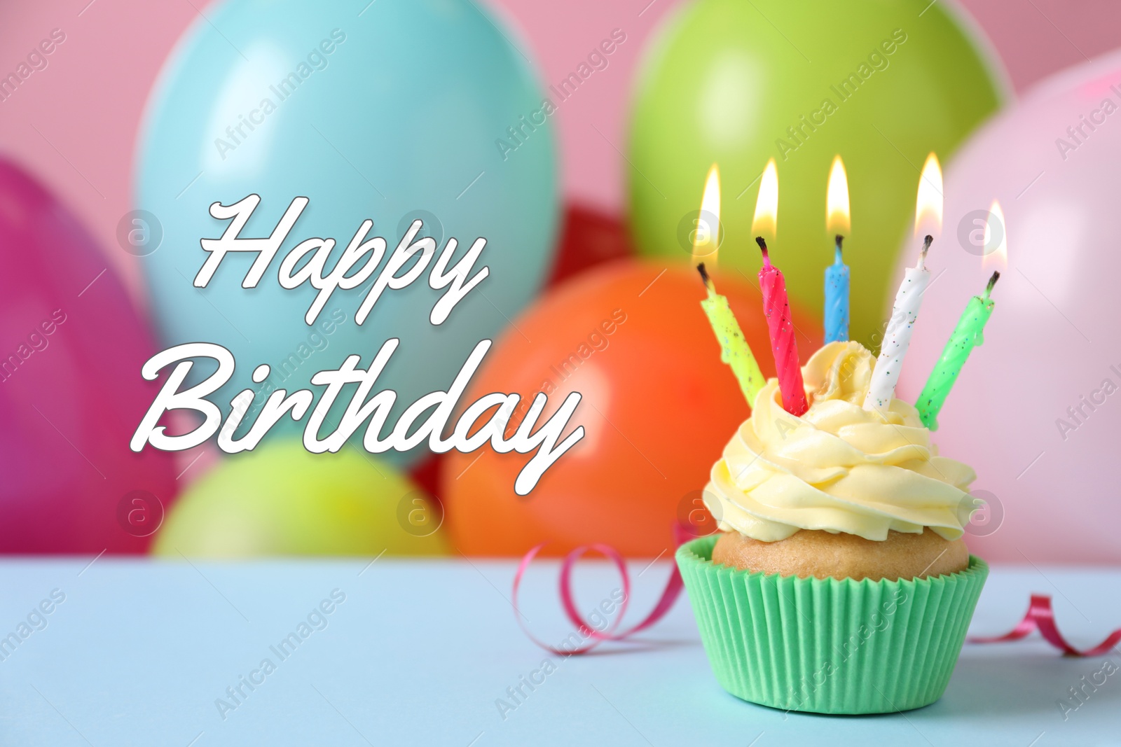 Image of Happy Birthday. Cupcake with candles against colorful balloons