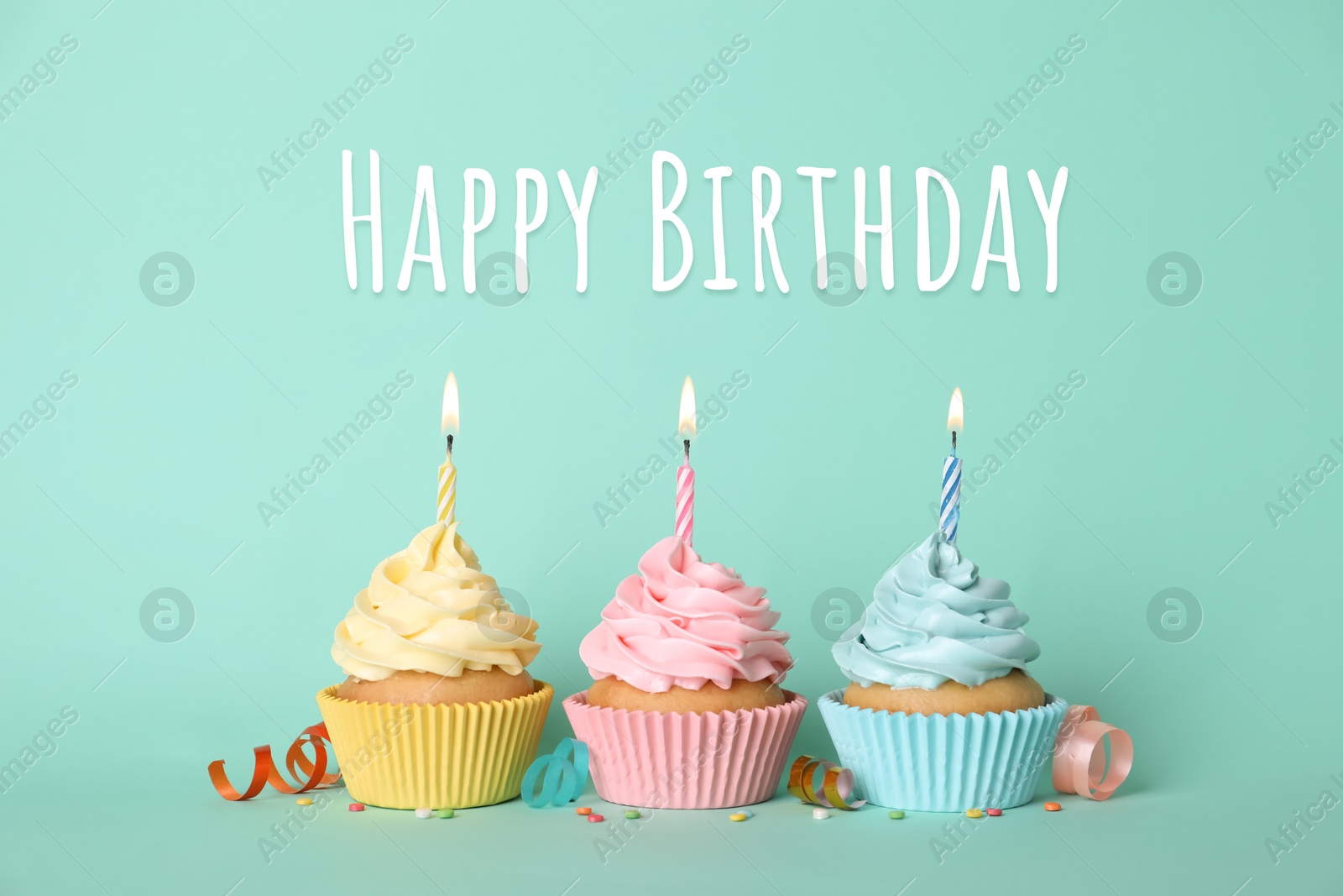 Image of Birthday cupcakes with candles on turquoise background. Greeting card