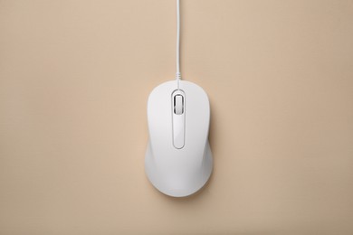 Photo of One wired mouse on beige background, top view