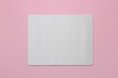 Photo of One mouse pad on pink background, top view. Space for text