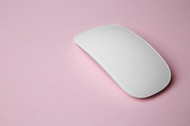 Photo of One wireless mouse on pink background. Space for text